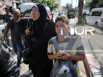 Palestinians flee with their belongings in Deir el-Balah, Gaza Strip, on August 21, 2024, amid the ongoing conflict between Israel and the H...