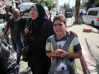 Palestinians flee with their belongings in Deir el-Balah, Gaza Strip, on August 21, 2024, amid the ongoing conflict between Israel and the H...