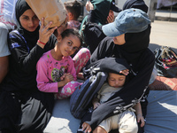 Palestinians flee with their belongings in Deir el-Balah, Gaza Strip, on August 21, 2024, amid the ongoing conflict between Israel and the H...