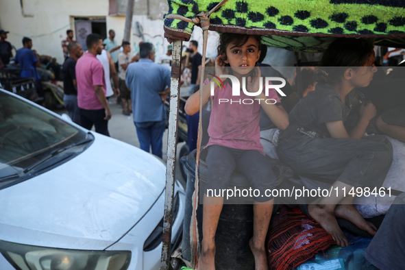 Palestinians flee with their belongings in Deir el-Balah, Gaza Strip, on August 21, 2024, amid the ongoing conflict between Israel and the H...