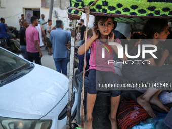 Palestinians flee with their belongings in Deir el-Balah, Gaza Strip, on August 21, 2024, amid the ongoing conflict between Israel and the H...