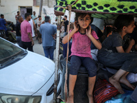 Palestinians flee with their belongings in Deir el-Balah, Gaza Strip, on August 21, 2024, amid the ongoing conflict between Israel and the H...