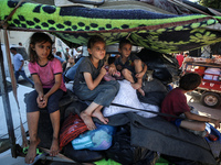 Palestinians flee with their belongings in Deir el-Balah, Gaza Strip, on August 21, 2024, amid the ongoing conflict between Israel and the H...