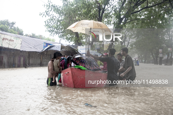 On August 21, 2024, in Feni, Bangladesh, volunteers in the Munsirhat area of Feni district in the Chittagong division of Bangladesh take wom...