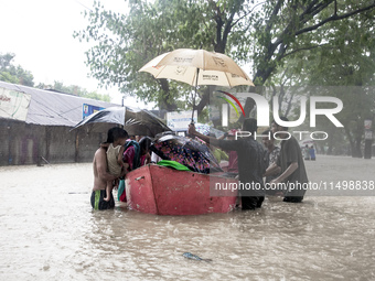 On August 21, 2024, in Feni, Bangladesh, volunteers in the Munsirhat area of Feni district in the Chittagong division of Bangladesh take wom...