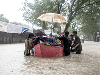 On August 21, 2024, in Feni, Bangladesh, volunteers in the Munsirhat area of Feni district in the Chittagong division of Bangladesh take wom...