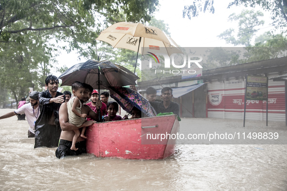 On August 21, 2024, in Feni, Bangladesh, volunteers in the Munsirhat area of Feni district in the Chittagong division of Bangladesh take wom...