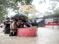 On August 21, 2024, in Feni, Bangladesh, volunteers in the Munsirhat area of Feni district in the Chittagong division of Bangladesh take wom...