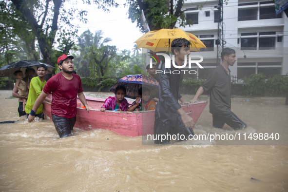 On August 21, 2024, in Feni, Bangladesh, volunteers in the Munsirhat area of Feni district in the Chittagong division of Bangladesh take wom...