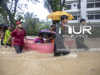 On August 21, 2024, in Feni, Bangladesh, volunteers in the Munsirhat area of Feni district in the Chittagong division of Bangladesh take wom...