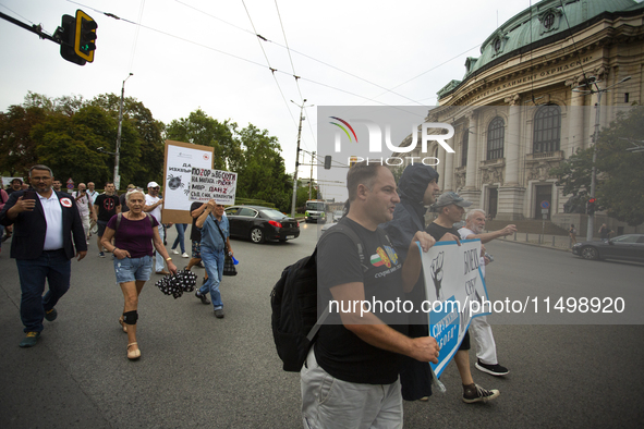 Protesters march and blockade the key intersection Eagle's Bridge in Sofia, Bulgaria, on August 21, 2024, demanding the resignation of caret...