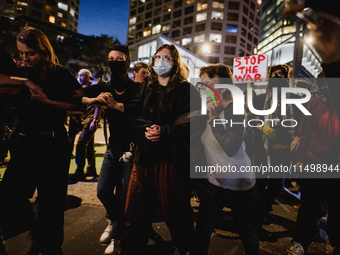 Pro-Palestine protesters hold a ''Make it Great Like '68'' protest in front of the Israeli consulate in Chicago, United States, on August 20...