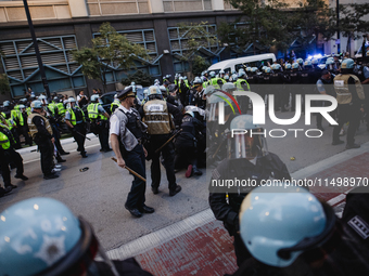 Pro-Palestine protesters hold a ''Make it Great Like '68'' protest in front of the Israeli consulate in Chicago, United States, on August 20...