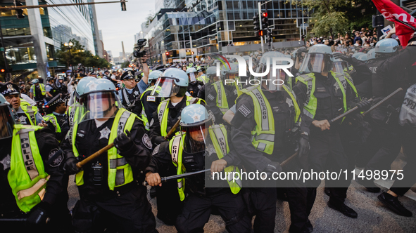 Pro-Palestine protesters hold a ''Make it Great Like '68'' protest in front of the Israeli consulate in Chicago, United States, on August 20...