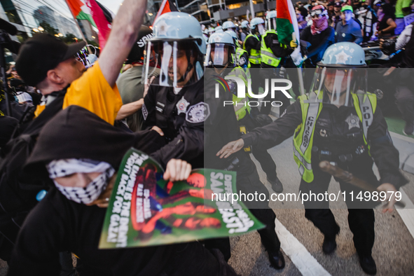 Pro-Palestine protesters hold a ''Make it Great Like '68'' protest in front of the Israeli consulate in Chicago, United States, on August 20...