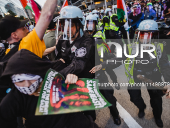 Pro-Palestine protesters hold a ''Make it Great Like '68'' protest in front of the Israeli consulate in Chicago, United States, on August 20...