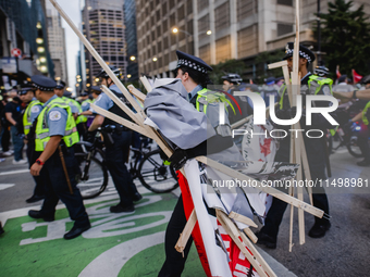 Pro-Palestine protesters hold a ''Make it Great Like '68'' protest in front of the Israeli consulate in Chicago, United States, on August 20...