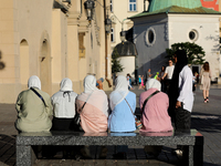 Tourists from the Middle East are seen on the Main Square in Krakow, Poland, on August 13, 2024. (