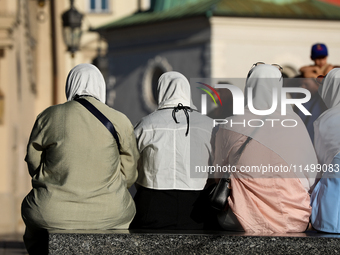 Tourists from the Middle East are seen on the Main Square in Krakow, Poland, on August 13, 2024. (