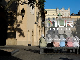 Tourists from the Middle East are seen on the Main Square in Krakow, Poland, on August 13, 2024. (