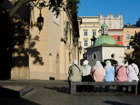 Tourists from the Middle East are seen on the Main Square in Krakow, Poland, on August 13, 2024. (