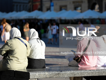 Tourists from the Middle East are seen on the Main Square in Krakow, Poland, on August 13, 2024. (