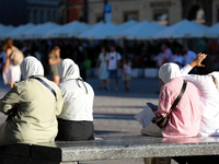 Tourists from the Middle East are seen on the Main Square in Krakow, Poland, on August 13, 2024. (