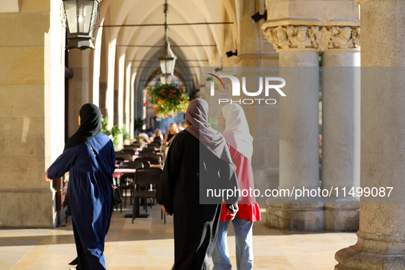 Tourists from the Middle East are seen on the Main Square in Krakow, Poland, on August 13, 2024. 