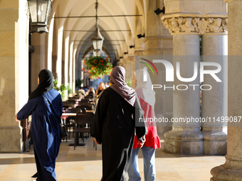 Tourists from the Middle East are seen on the Main Square in Krakow, Poland, on August 13, 2024. (