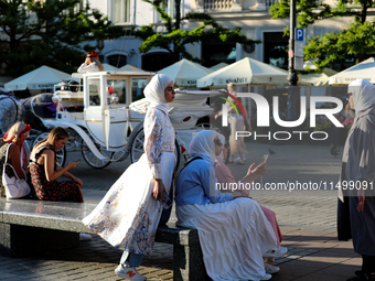 Tourists from the Middle East are seen on the Main Square in Krakow, Poland, on August 13, 2024. (