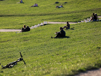 People spend their free time on the boulevards along the Vistula River in Krakow, Poland, on August 13, 2024. (