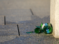 A broken glass beer bottle is seen on the street in Krakow, Poland, on August 13, 2024. (