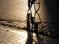 People during sunset are seen on the Main Square in Krakow, Poland, on August 13, 2024. (