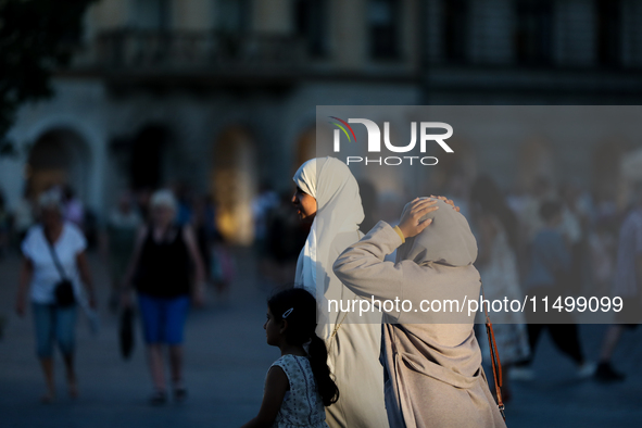 Tourists from the Middle East are seen on the Main Square in Krakow, Poland, on August 13, 2024. 