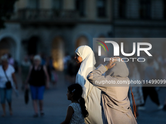 Tourists from the Middle East are seen on the Main Square in Krakow, Poland, on August 13, 2024. (