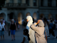 Tourists from the Middle East are seen on the Main Square in Krakow, Poland, on August 13, 2024. (