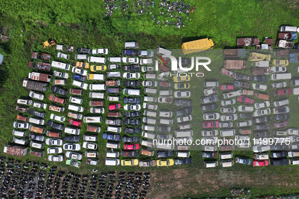 An aerial photo taken on August 22, 2024, shows a large number of cars and motorcycles waiting to be dismantled at a scrap point for discard...