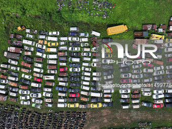 An aerial photo taken on August 22, 2024, shows a large number of cars and motorcycles waiting to be dismantled at a scrap point for discard...