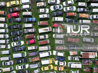 An aerial photo taken on August 22, 2024, shows a large number of cars and motorcycles waiting to be dismantled at a scrap point for discard...