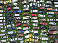 An aerial photo taken on August 22, 2024, shows a large number of cars and motorcycles waiting to be dismantled at a scrap point for discard...