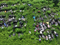 An aerial photo taken on August 22, 2024, shows a large number of cars and motorcycles waiting to be dismantled at a scrap point for discard...