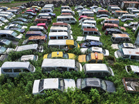 An aerial photo taken on August 22, 2024, shows a large number of cars and motorcycles waiting to be dismantled at a scrap point for discard...