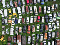 An aerial photo taken on August 22, 2024, shows a large number of cars and motorcycles waiting to be dismantled at a scrap point for discard...