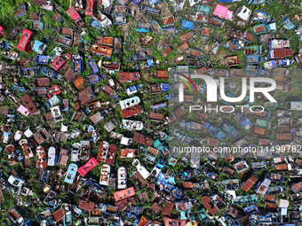 An aerial photo taken on August 22, 2024, shows a large number of cars and motorcycles waiting to be dismantled at a scrap point for discard...