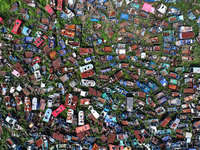 An aerial photo taken on August 22, 2024, shows a large number of cars and motorcycles waiting to be dismantled at a scrap point for discard...