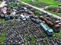 An aerial photo taken on August 22, 2024, shows a large number of cars and motorcycles waiting to be dismantled at a scrap point for discard...