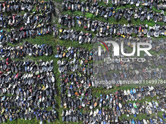 An aerial photo taken on August 22, 2024, shows a large number of cars and motorcycles waiting to be dismantled at a scrap point for discard...