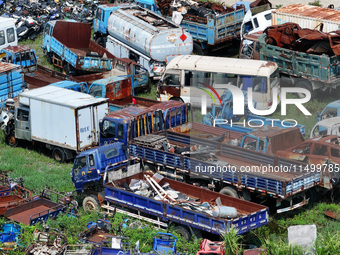 An aerial photo taken on August 22, 2024, shows a large number of cars and motorcycles waiting to be dismantled at a scrap point for discard...