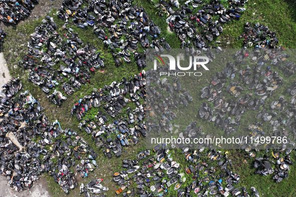 An aerial photo taken on August 22, 2024, shows a large number of cars and motorcycles waiting to be dismantled at a scrap point for discard...