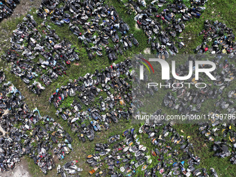 An aerial photo taken on August 22, 2024, shows a large number of cars and motorcycles waiting to be dismantled at a scrap point for discard...